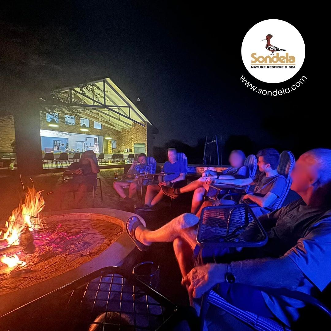 Guests relaxing around the boma firepit at Sondela Nature Reserve in the evening
