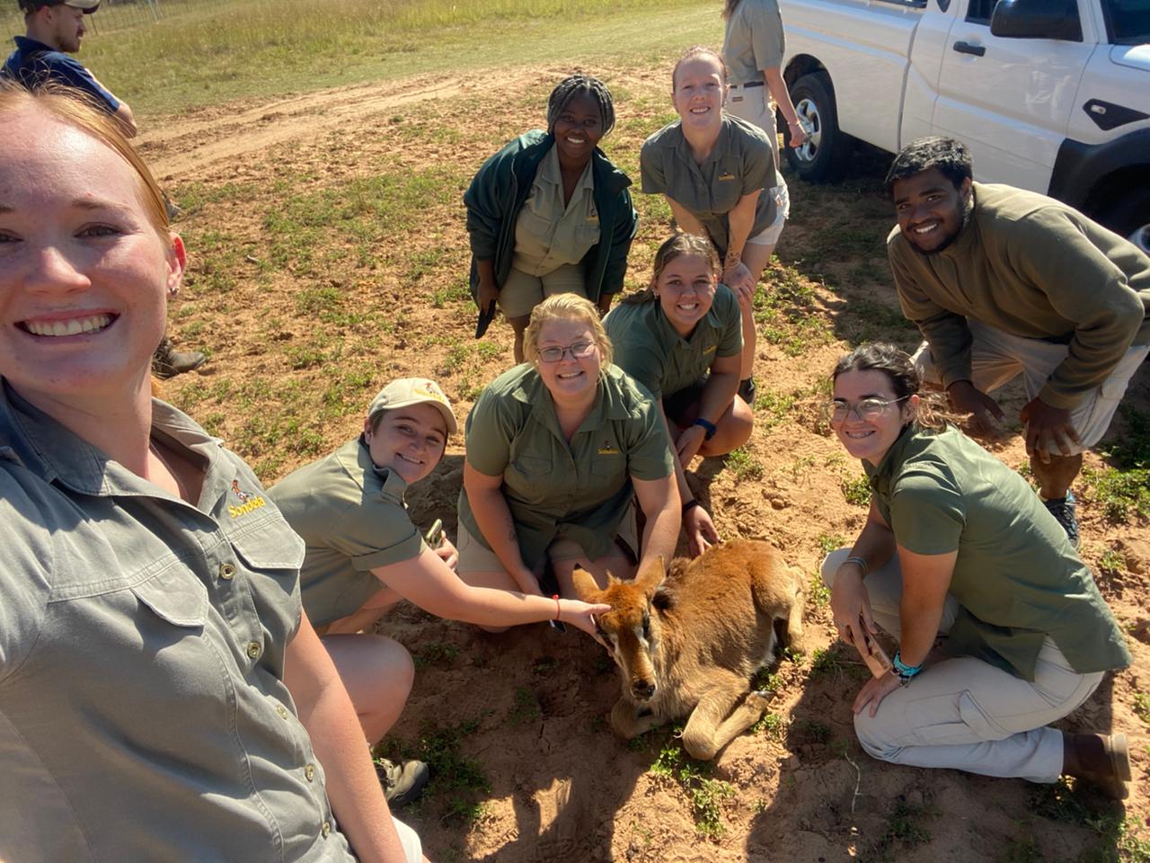 Sondela Academy conservation students with a young antelope during fieldwork on the reserve